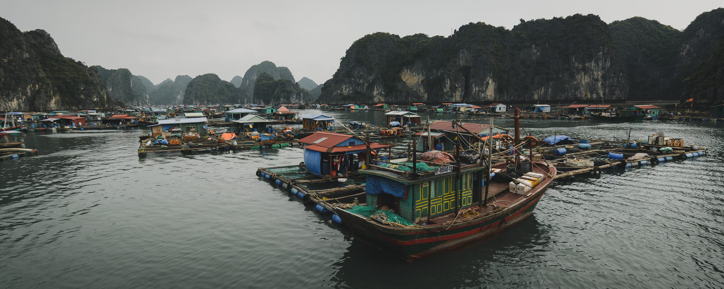 Fishing boats beneath limestone islands in Vietnam